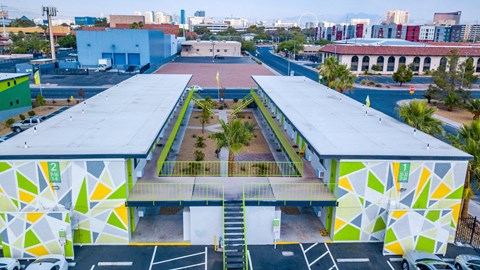 Aerial view of Fusion Las Vegas apartment complex in 89119 with green, yellow, and grey geometric painted walls and lime green railing